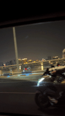 Nighttime drive through illuminated Yuzhong District captured on video