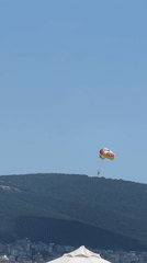 Parasails over a packed Sunny Beach on a summer morning