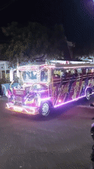 Neon-lit streets and motorbike traffic in Kepuh Kiriman at night