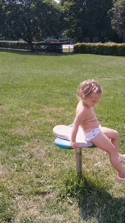 Sunny afternoon playground session on the spinning toys in Sokolov
