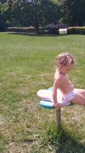 Sunny afternoon playground session on the spinning toys in Sokolov