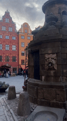Tourist documents afternoon stroll through Stockholm's historic Old Town
