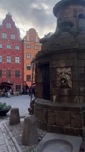 Tourist documents afternoon stroll through Stockholm's historic Old Town