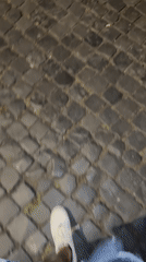 Evening walk captures illuminated Colosseum and Constantine Arch in Rome