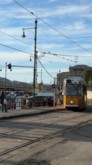 Tram and convertible cross paths near Chain Bridge Budapest