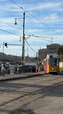Tram and convertible cross paths near Chain Bridge Budapest