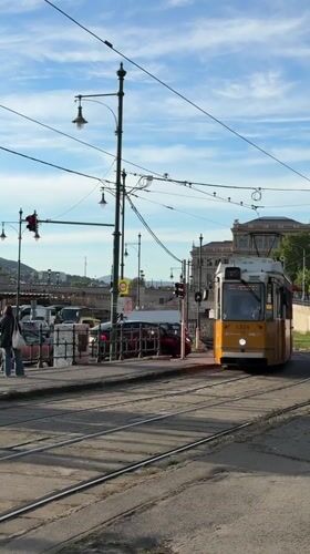 Tram and convertible cross paths near Chain Bridge Budapest
