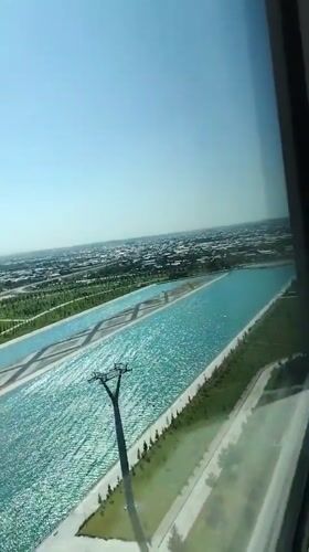 Uzbekistan resort complex with waterways, patios, and fresh flowers