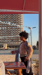 Woman in colorful attire spotted during golden hour in Tel-Aviv