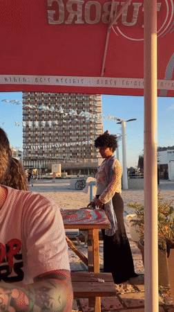 Woman in colorful attire spotted during golden hour in Tel-Aviv