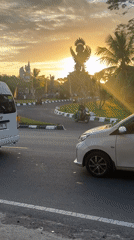 Evening traffic flows past Garuda Wisnu Kencana statue in Bali