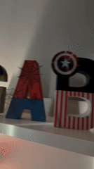 Superhero-themed wooden letters spell "GABRIEL" on Luxembourg shelf