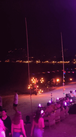 Nighttime pool party with blue lights in บ้านบางรักษ์, Thailand