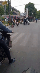 Morning motorcycle traffic flows through Banjarmasin streets