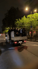 Pickup truck carries dozen young people through Paris streets