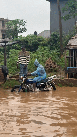 Floodwaters swamp streets and vehicles in Ihiagwa, Nigeria