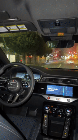 Inside a Jaguar at night, Los Angeles streets ahead