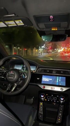 Inside a Jaguar at night, Los Angeles streets ahead