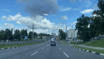 Driving through Kharkiv on a wide road under summer skies