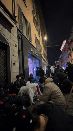 Nighttime gathering outside building in Bergamo, Italy