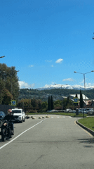 Motorcyclist in red helmet captured on video during sunny day