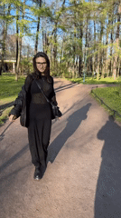 Woman enjoys cake, observes families in sunny Saint Petersburg park