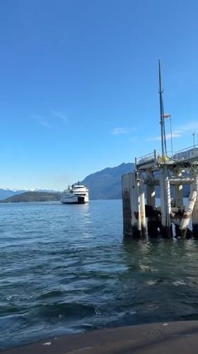 Ferry crosses West Vancouver waters under partly cloudy skies