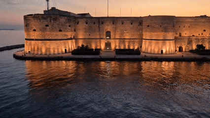 Taranto at dusk: castle, harbor, and Mediterranean Games 2026