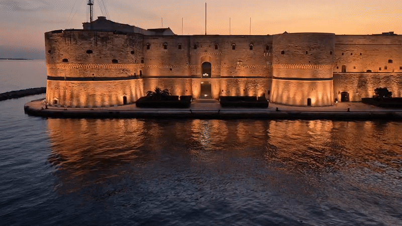 Taranto at dusk: castle, harbor, and Mediterranean Games 2026
