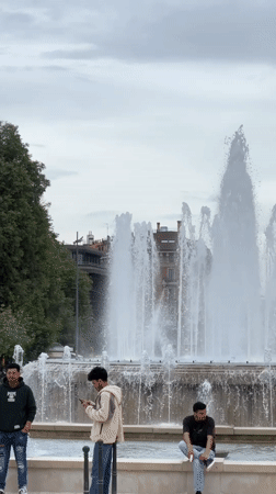 Young men gather near fountain in Milan park