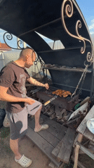 Family barbecue gathering with grilled chicken in Chaikovsky, Russia