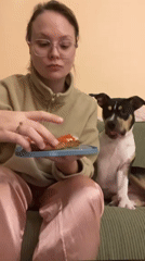 Woman in pajamas enjoys meal on couch in Tel Aviv
