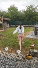 Woman runs toward backyard pool in Bulgarian village