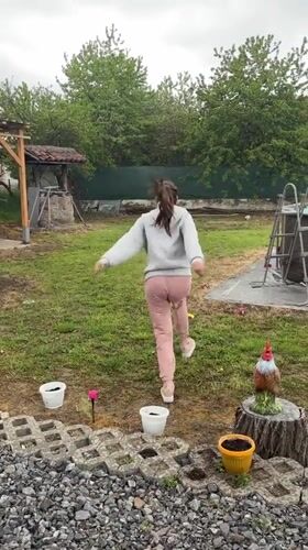 Woman runs toward backyard pool in Bulgarian village