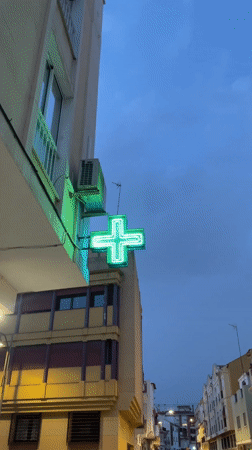 Person takes mirror selfies, holds raw fish plate in Málaga