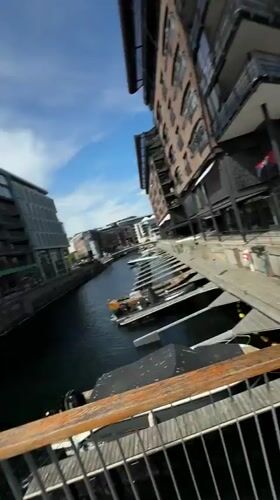 Sunny day at Oslo harbor with boats and castle