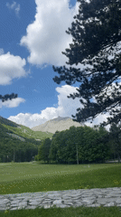Mountain picnic gathering observed amid distant forest smoke Montenegro