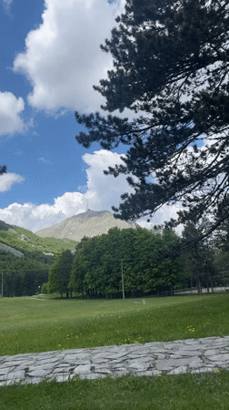 Mountain picnic gathering observed amid distant forest smoke Montenegro
