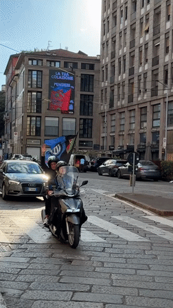 Everyday street scene documented in Milan's cobblestone district