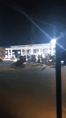 Crowd gathers at Lokoja gas station with vehicles present