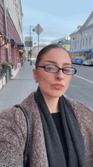Woman takes selfie on Moscow sidewalk