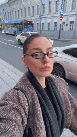 Woman takes selfie on Moscow sidewalk