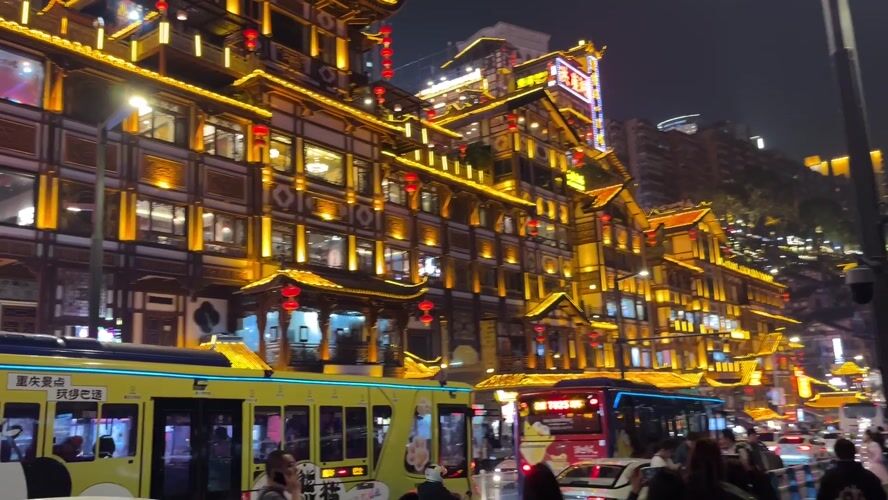 Tourists gather at illuminated Hongyadong district in Chongqing evening