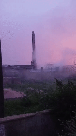 Drilling rig operates at sunset in Jos, Nigeria