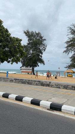 Late night beach volleyball and cycling activity in Karon
