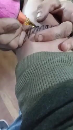 Tattoo session documented in Stilwell, existing forearm tattoo visible