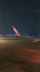 Passenger documents nighttime Air Asia operations at Vietnam airport