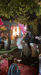 Evening celebration features pyrotechnics display in garden courtyard setting