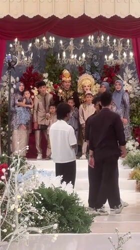 Traditional wedding ceremony with elaborate floral decorations in Lhokseumawe