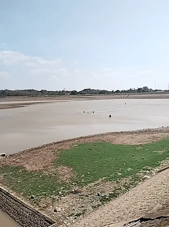 Low reservoir levels in Central Java, locals fishing the shoreline